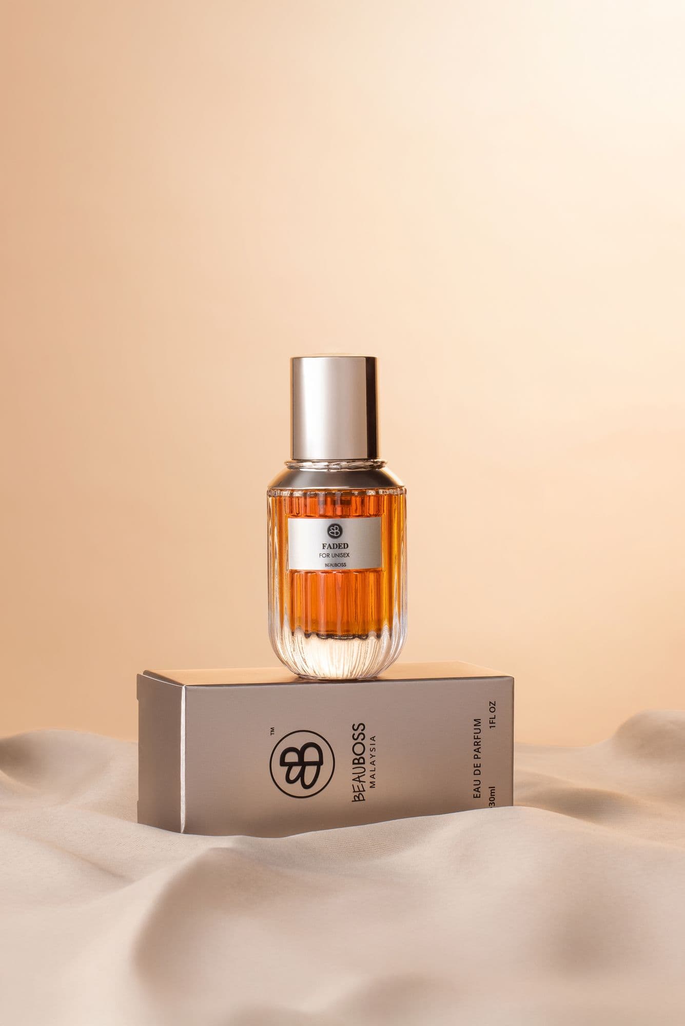 Beauboss perfume bottle and gift box on draped satin