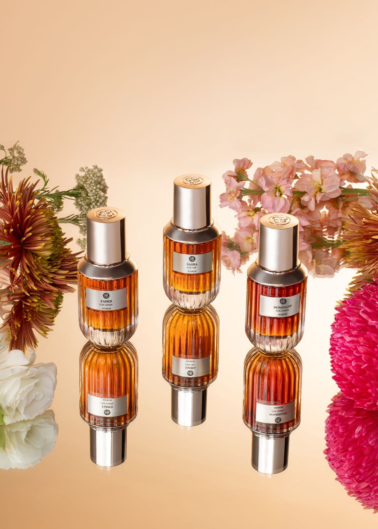 Row of Beauboss perfume bottles framed by pink florals